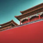 a red wall with a building in the background